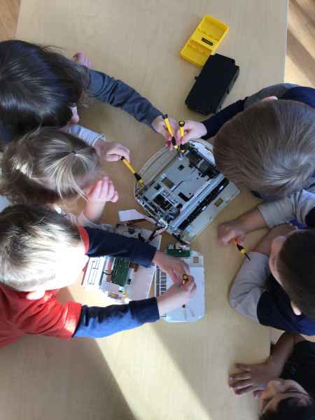 children pulling aparty old electronics to investigate